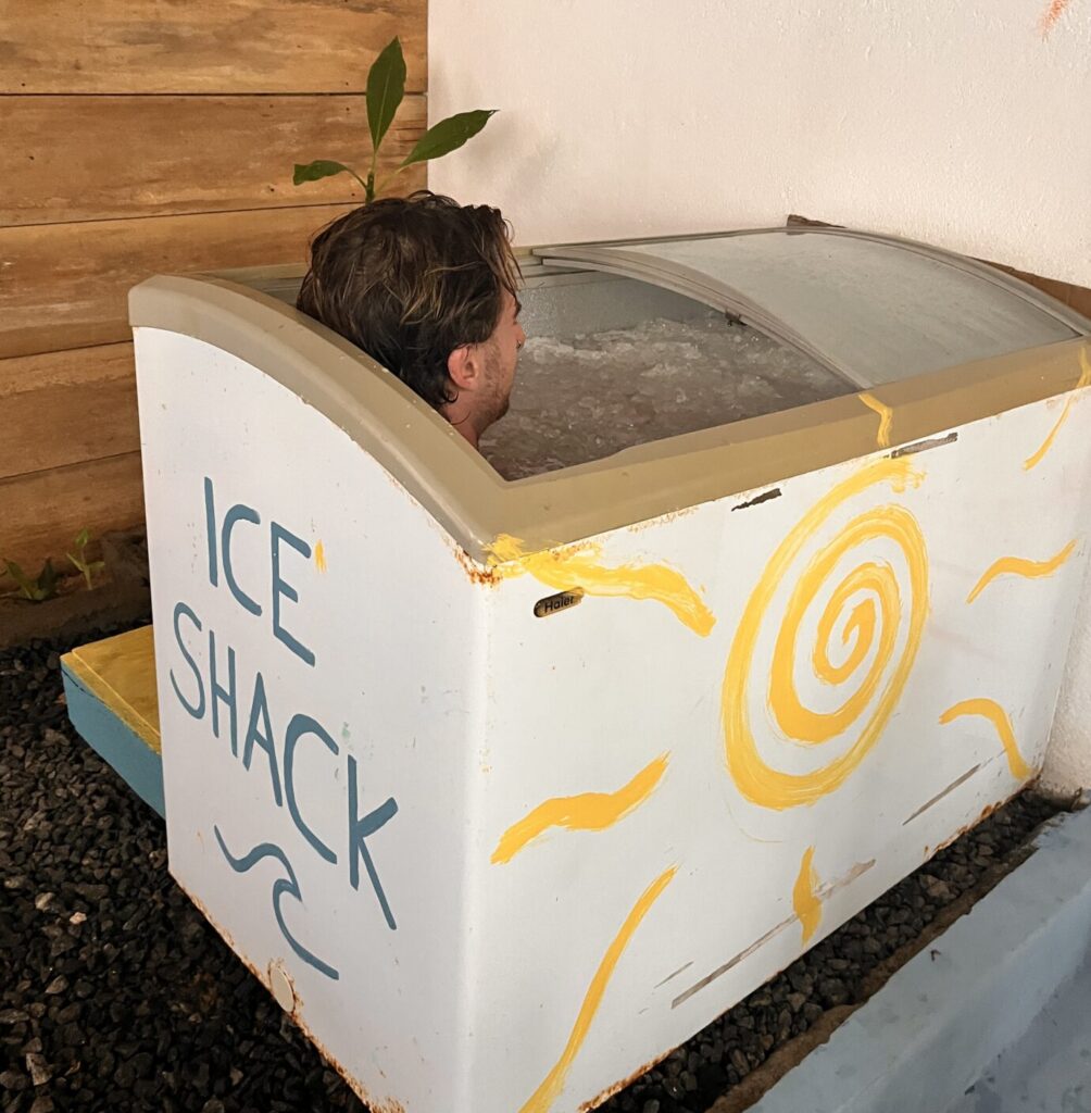Man submerged to the neck in an Ice Shack cold plunge, using breathwork for nervous system regulation