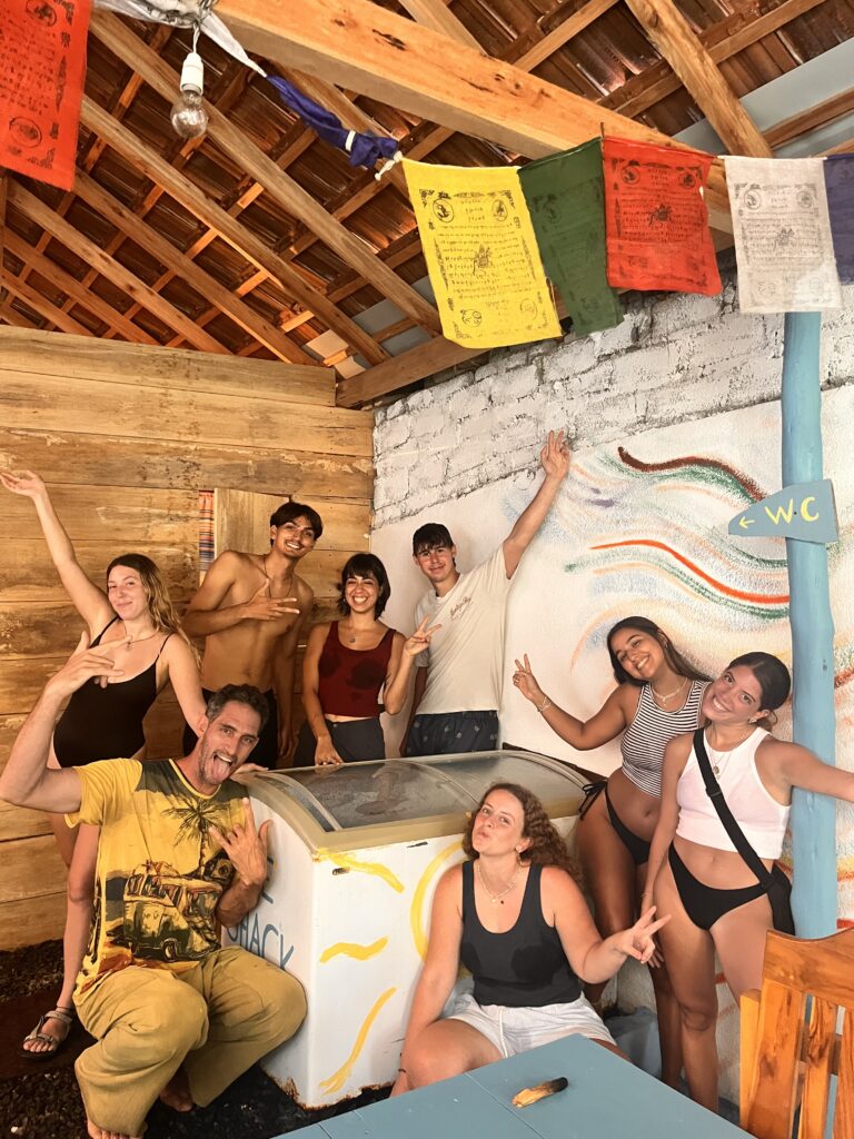 Group smiling around the Ice Shack cold plunge after an ice bath breathwork session in Arugam Bay